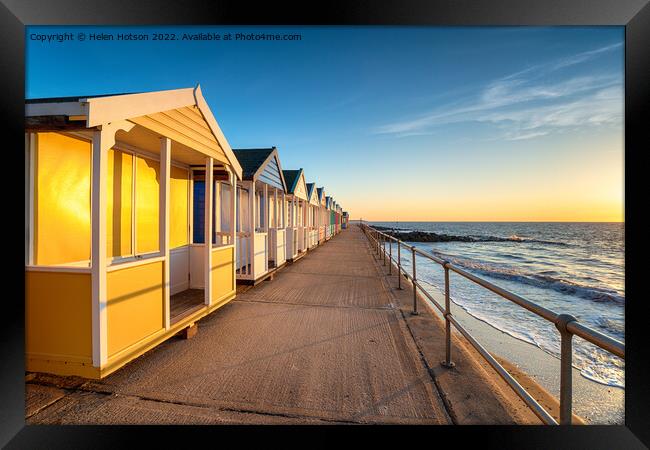 Colorful beach huts on the prom at Southwold Framed Print by Helen Hotson