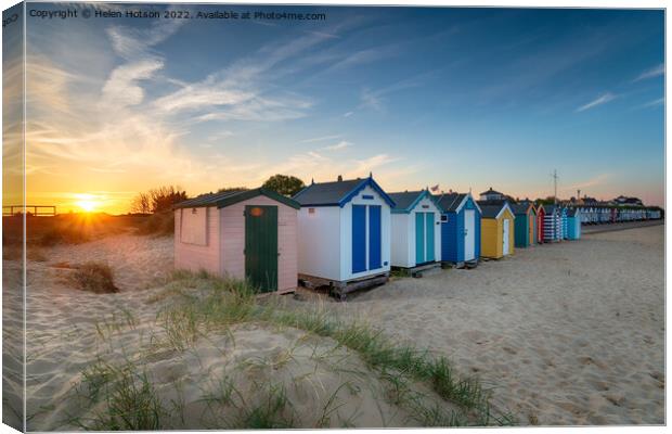 Sunset over a row of beach huts at Southwold  Canvas Print by Helen Hotson