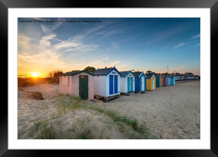 Sunset over a row of beach huts at Southwold  Framed Mounted Print by Helen Hotson