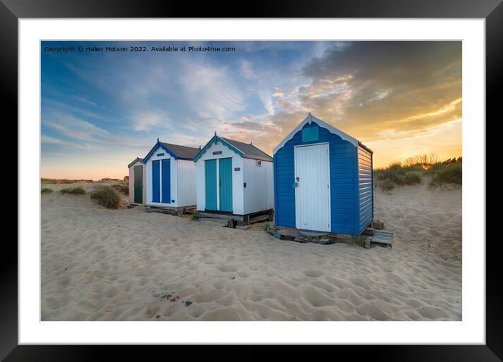 Sunset over a row of pretty beach huts at Southwold  Framed Mounted Print by Helen Hotson