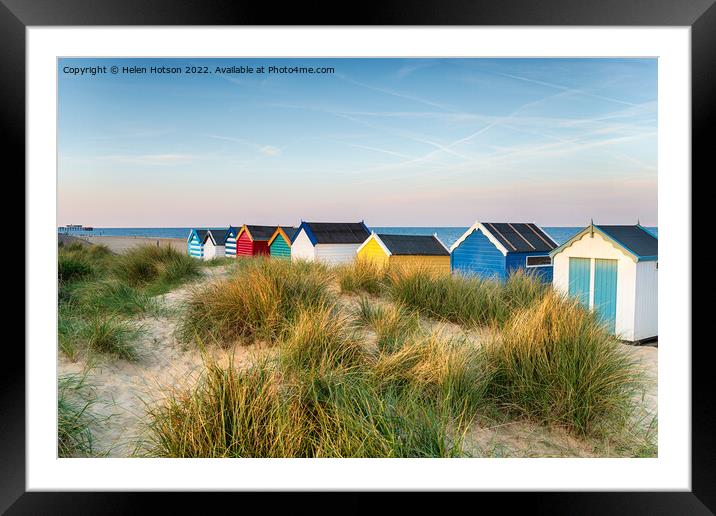 Beach huts in the sand dunes at Southwold  Framed Mounted Print by Helen Hotson
