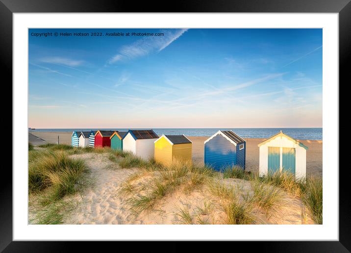 Beach huts in sand dunes at Southwold  Framed Mounted Print by Helen Hotson