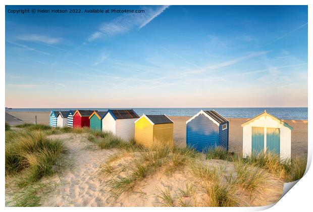 Beach huts in sand dunes at Southwold  Print by Helen Hotson