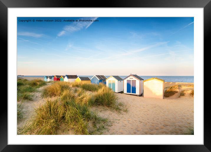 Colourfull beach huts in the sand dunes at Southwold Framed Mounted Print by Helen Hotson