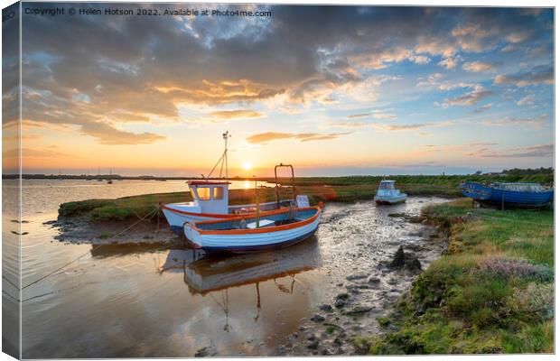 Stunning sunset over old fishing boats Canvas Print by Helen Hotson