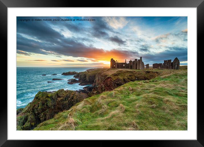 Dramatic sunset over the ruins Slains Castle Framed Mounted Print by Helen Hotson