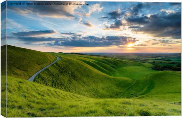 Dramatic sunset sky over The Manger at Uffington Canvas Print by Helen Hotson