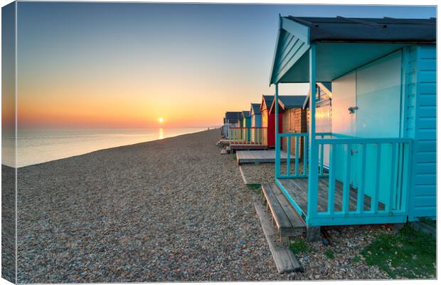 Stunning sunset over seaside beach huts  Canvas Print by Helen Hotson