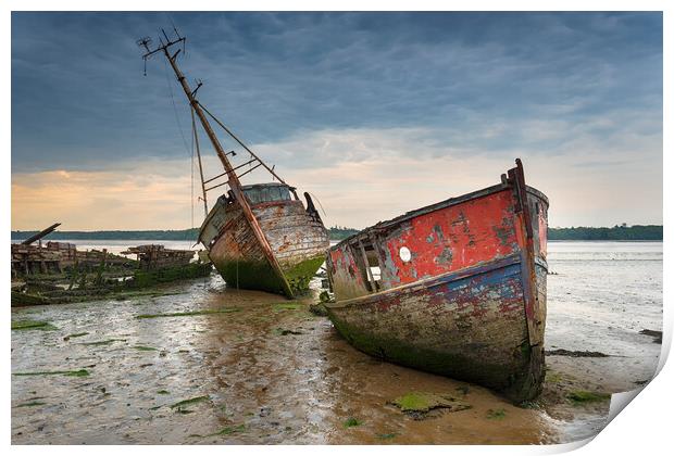 Old boat wrecks under a stormy sky Print by Helen Hotson