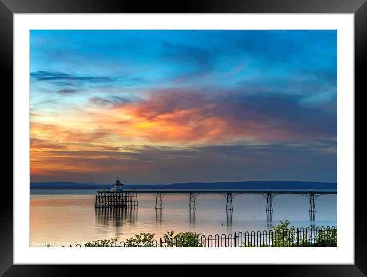 Clevedon Pier with the setting sun lighting up the cloud cover Framed Mounted Print by Rory Hailes