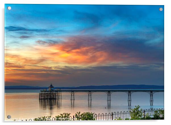 Clevedon Pier with the setting sun lighting up the cloud cover Acrylic by Rory Hailes