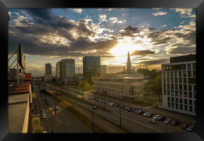 Wide angle aerial view of Lodz cityscape with mix of modern and medieval architecture next to highway against dramatic sunset Framed Print by Arpan Bhatia