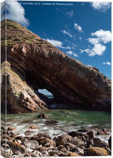 A natural sea arch near Portknockie on the north-e Canvas Print by Joe Dailly