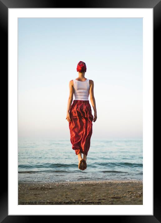 Woman jumping on the beach Framed Mounted Print by Simo Wave