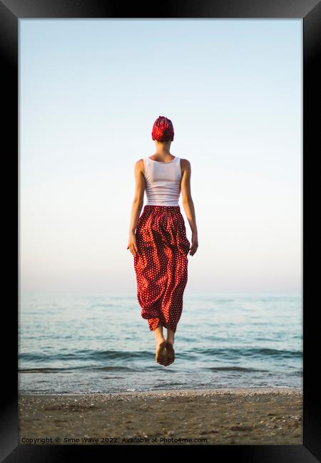 Woman jumping on the beach Framed Print by Simo Wave