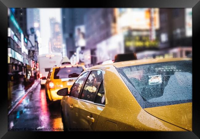 Taxi cab in the rain in NYC Framed Print by Simo Wave