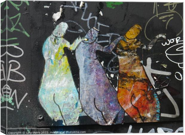 Graffiti depicting three figures standing next to each other. Canvas Print by Luigi Petro