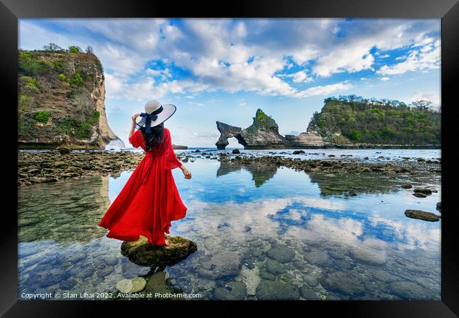 Woman standing on the rock at Atuh beach, Nusa penida island Framed Print by Stan Lihai