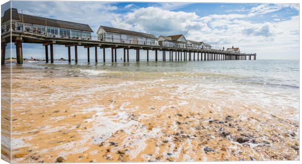 Waves wash back into the sea under Southwold Pier Canvas Print by Jason Wells