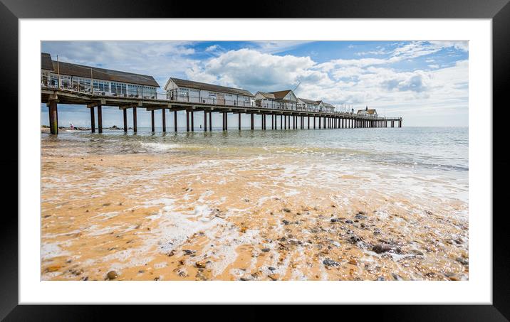 Waves wash back into the sea under Southwold Pier Framed Mounted Print by Jason Wells