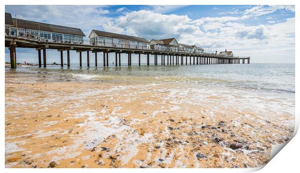 Waves wash back into the sea under Southwold Pier Print by Jason Wells
