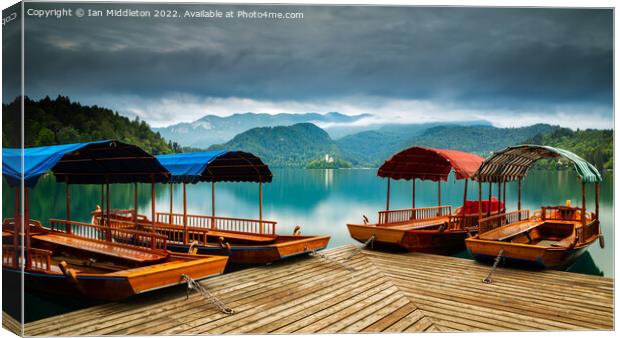 Pletna Boats at Lake Bled Canvas Print by Ian Middleton