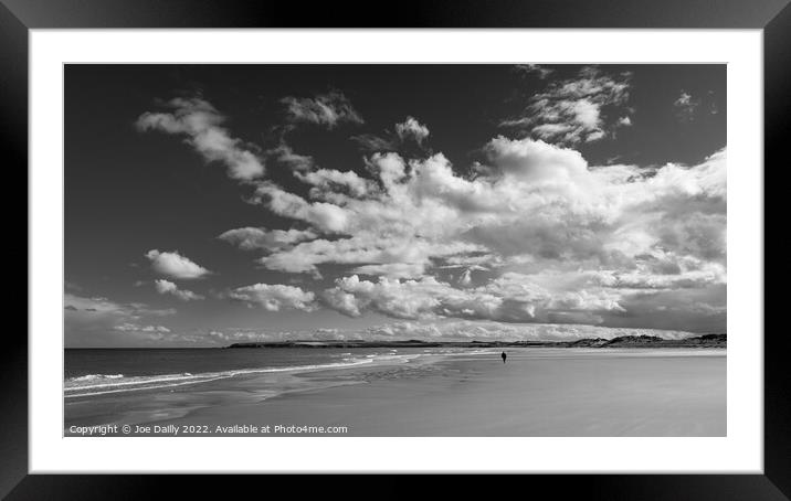 A lone beach walker under a dramatic sky Framed Mounted Print by Joe Dailly