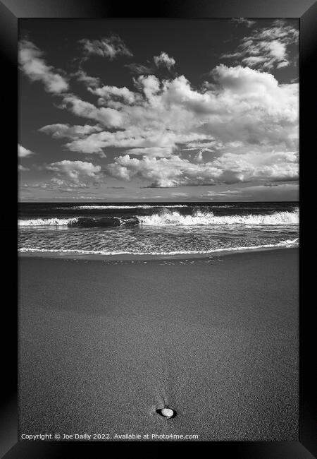Lone pebble on a monochrome beach Framed Print by Joe Dailly