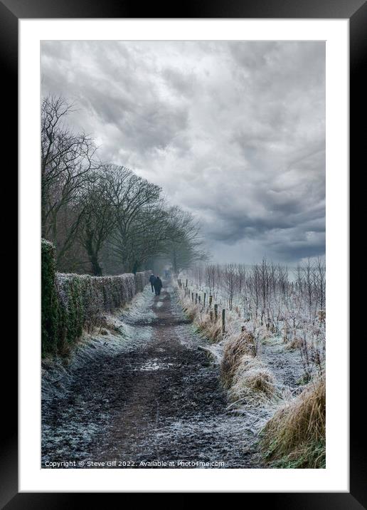 Ramblers Walking Along a Long Muddy Path on a Misty Winter Morning. Framed Mounted Print by Steve Gill