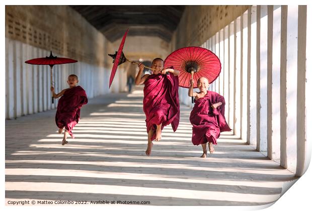 Novice monks with umbrellas running at temple, Bagan, Myanmar Print by Matteo Colombo