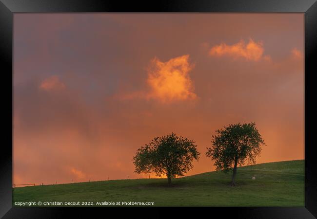 Orange sky at sunset in black forest. Framed Print by Christian Decout