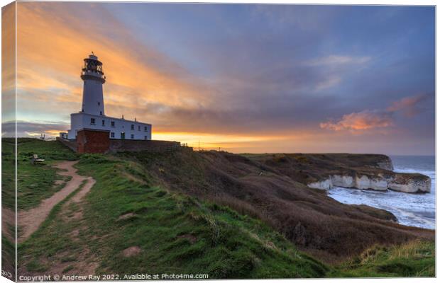 Setting sun behind Flamborough Lighthouse Canvas Print by Andrew Ray
