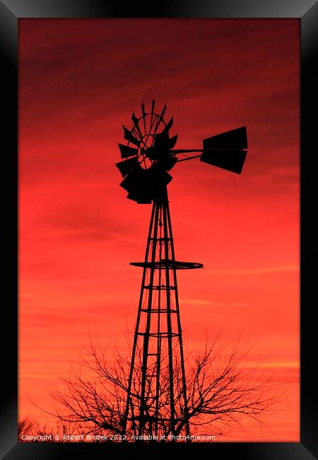Kansas Sunset with a red Sky and Windmill silhouet Framed Print by Robert Brozek