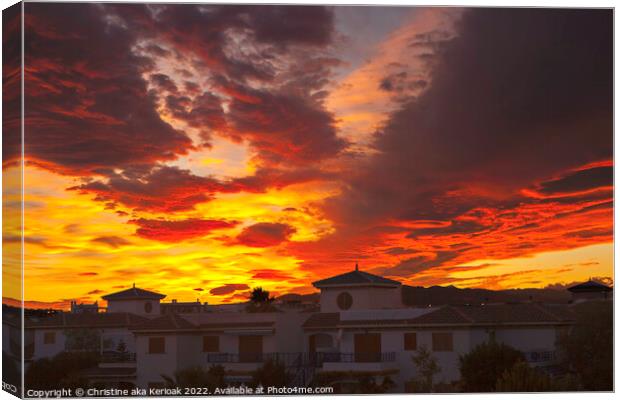 Fiery Sunset Over White Houses Canvas Print by Christine Kerioak