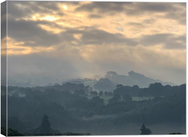 Amazing sky over a misty morning Canvas Print by Tim Clapham