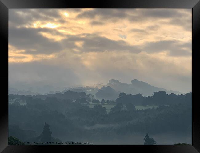 Amazing sky over a misty morning Framed Print by Tim Clapham