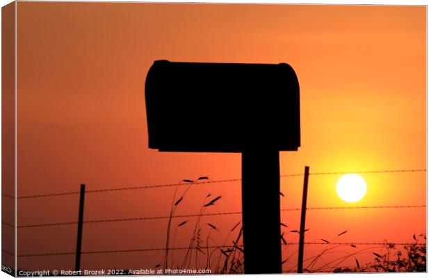 Mailbox silhouette at sunset with orange sky Canvas Print by Robert Brozek