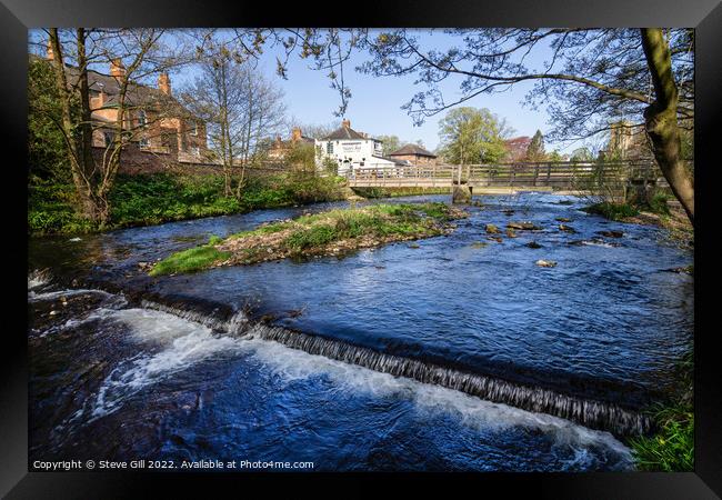 River Skell with a Small Weir and a Footbridge. Framed Print by Steve Gill