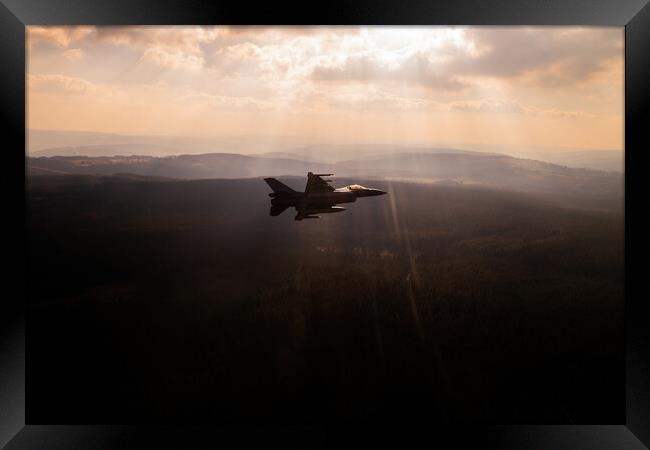 A fighter jet F-16 breaking away in a special light Framed Print by Bart Rosselle