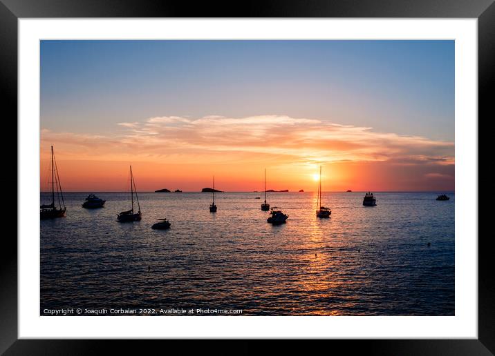 A warm sunset with the sun reflecting on the surface of the sea, Framed Mounted Print by Joaquin Corbalan