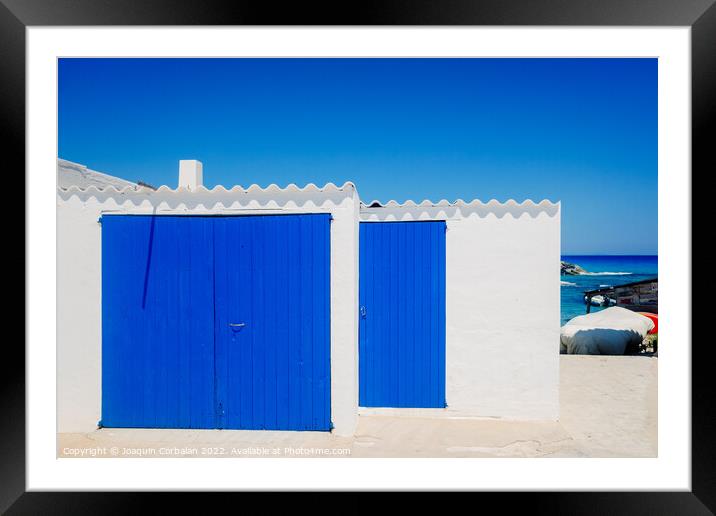 Fisherman's hut with white walls and colorful blue wooden doors  Framed Mounted Print by Joaquin Corbalan