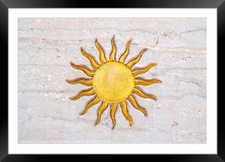 The drawing of a sun with golden rays engraved on marble on a wa Framed Mounted Print by Joaquin Corbalan