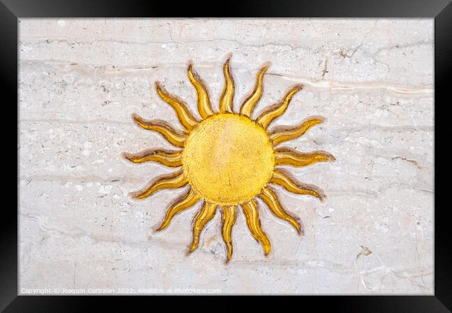 The drawing of a sun with golden rays engraved on marble on a wa Framed Print by Joaquin Corbalan