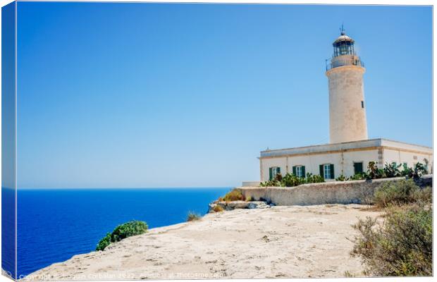 Formentera's lighthouse next to the sea cliff illuminates the co Canvas Print by Joaquin Corbalan