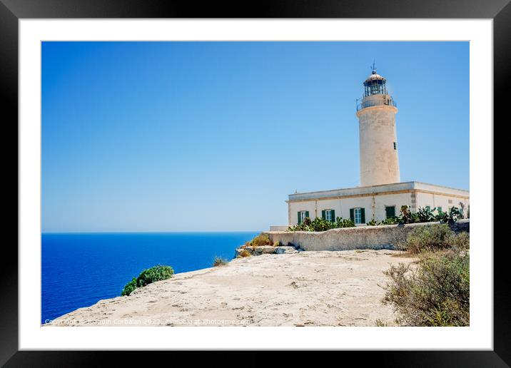 Formentera's lighthouse next to the sea cliff illuminates the co Framed Mounted Print by Joaquin Corbalan