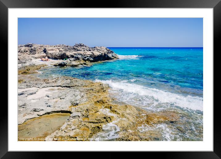 View of the transparent water of the sea on the coast from the r Framed Mounted Print by Joaquin Corbalan