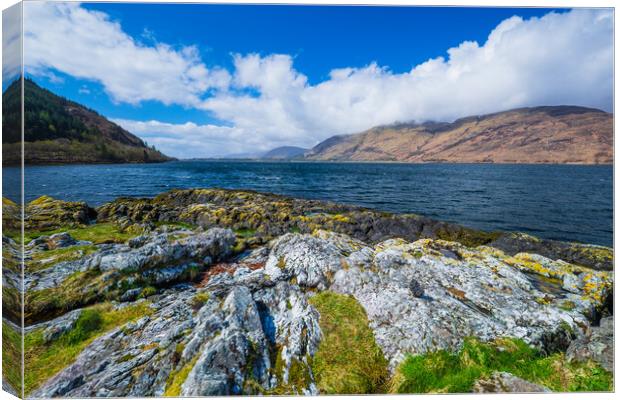 A rocky island in the middle of a body of water Canvas Print by Bill Allsopp