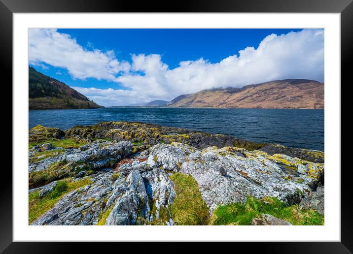 A rocky island in the middle of a body of water Framed Mounted Print by Bill Allsopp
