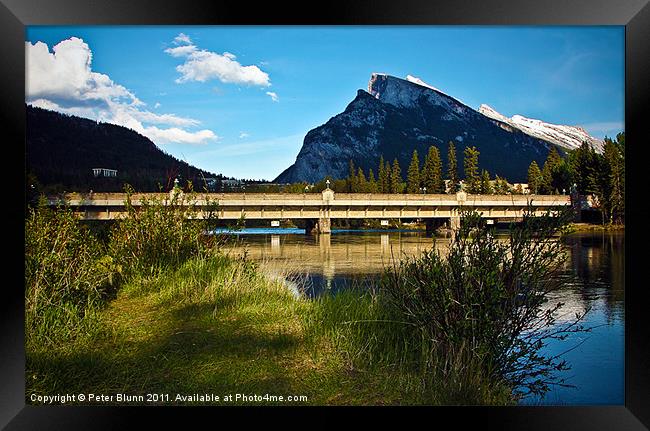 Rocky Mountain River Bridge Framed Print by Peter Blunn