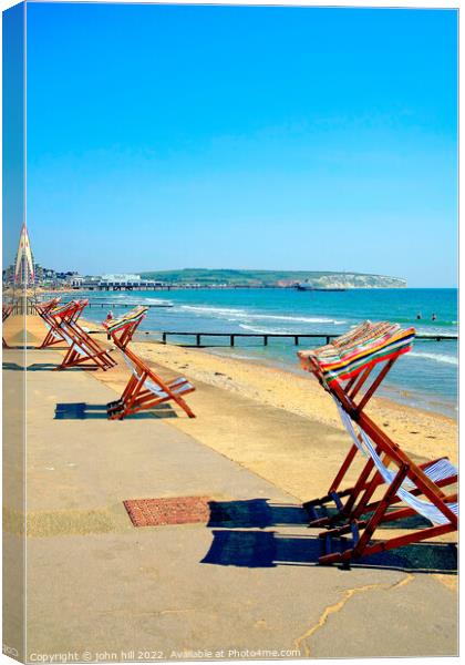 Early morning deckchairs at Sandown bay, Isle of Wight. Canvas Print by john hill